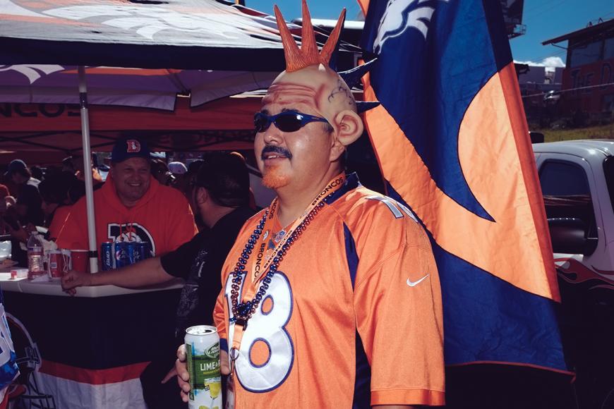 Broncos superfan in an orange jersey and bald cap with orange mohawk