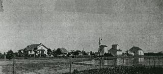 Historic photo of the NB5, LLC, showing the house and the grain elevator.
