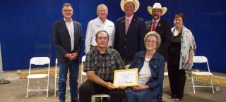 Ohr family members (seated) with their Centennial Farms certificate.
