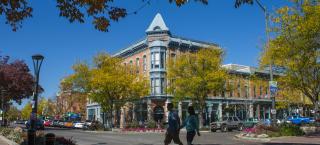 Fort Collins' historic Old Town district in the fall, with people walking along the street.