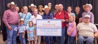 Haynes Hereford Ranch family with their Centennial Farm sign.