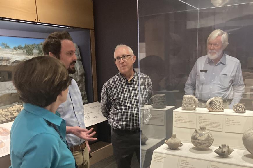 Colorado! Friends Circle members gather around an HC staff member and a display case showing Puebloan artifacts.