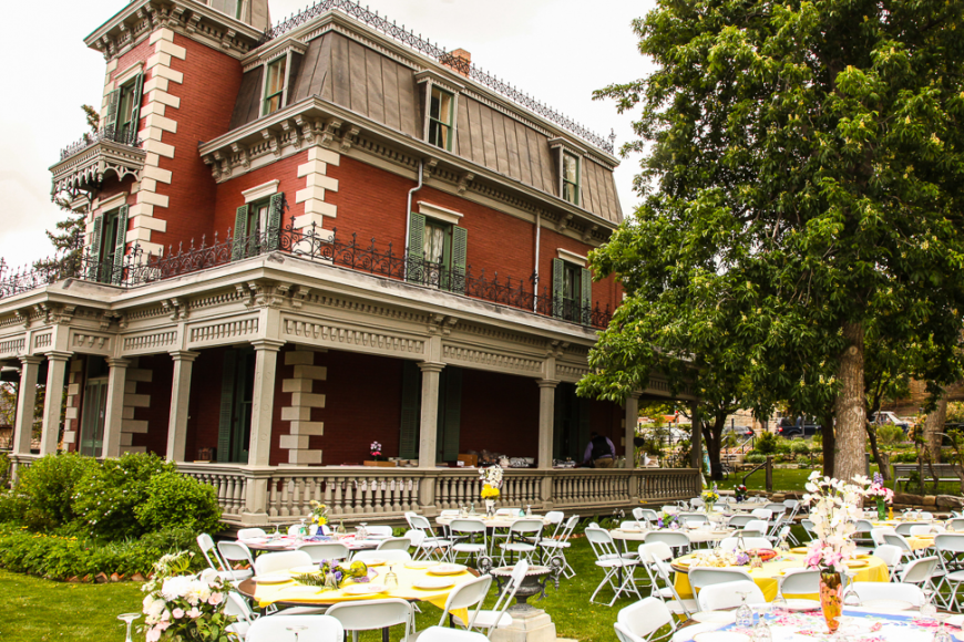 Wedding set up on the lawn of the Bloom Mansion with tables and chairs adorned with flowers.