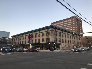 Photo of the Eleventh Avenue Hotel, a three-story rectangular brick building