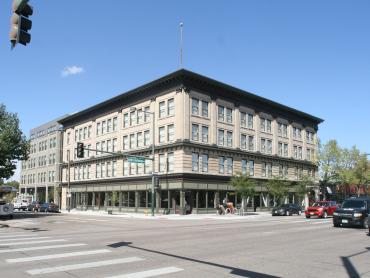 Photo of the First Avenue Hotel, a three-story brick building.