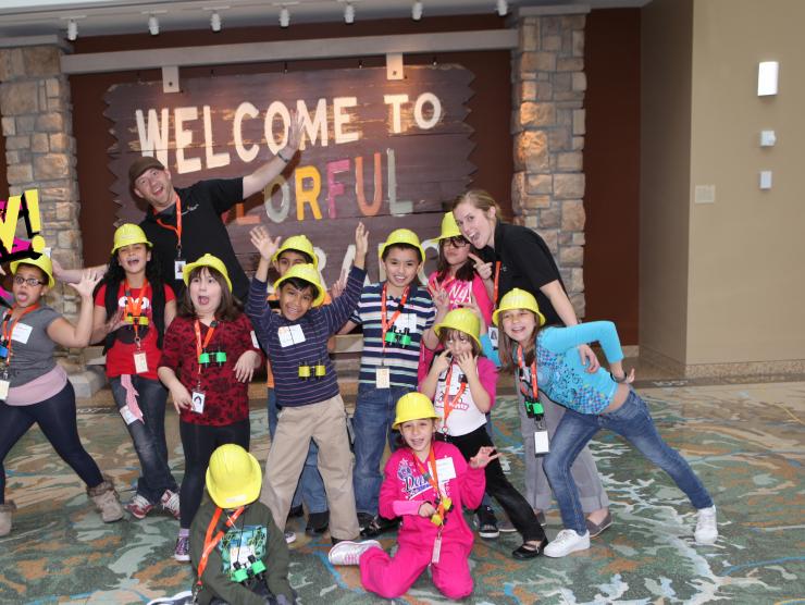 Kids in front of Colorado sign with kapow logo